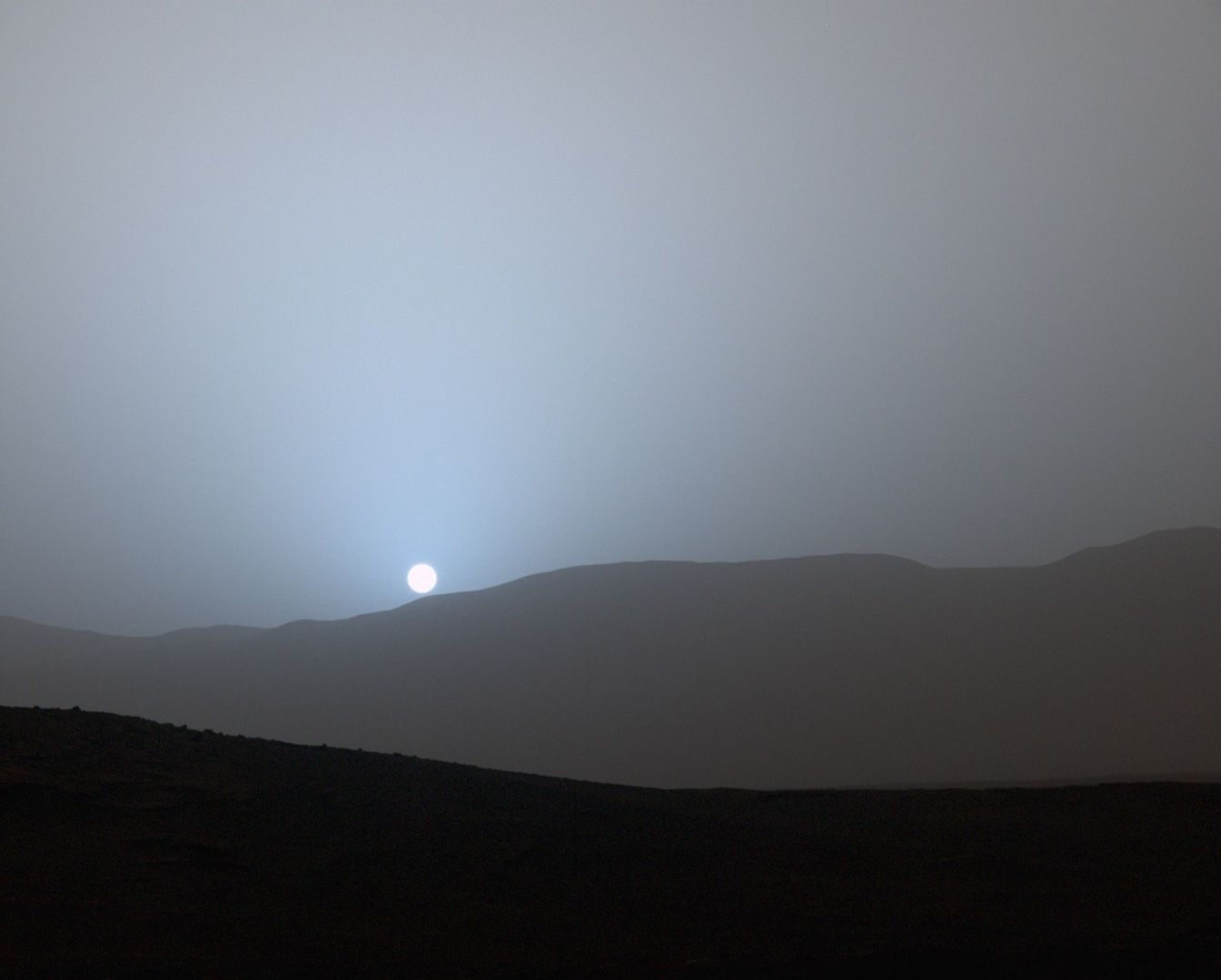 A blue grey sunset over mountains